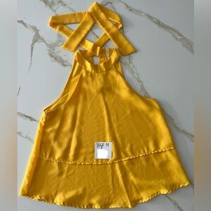 Size M halter tank for sale. Ties in back. Good condition.